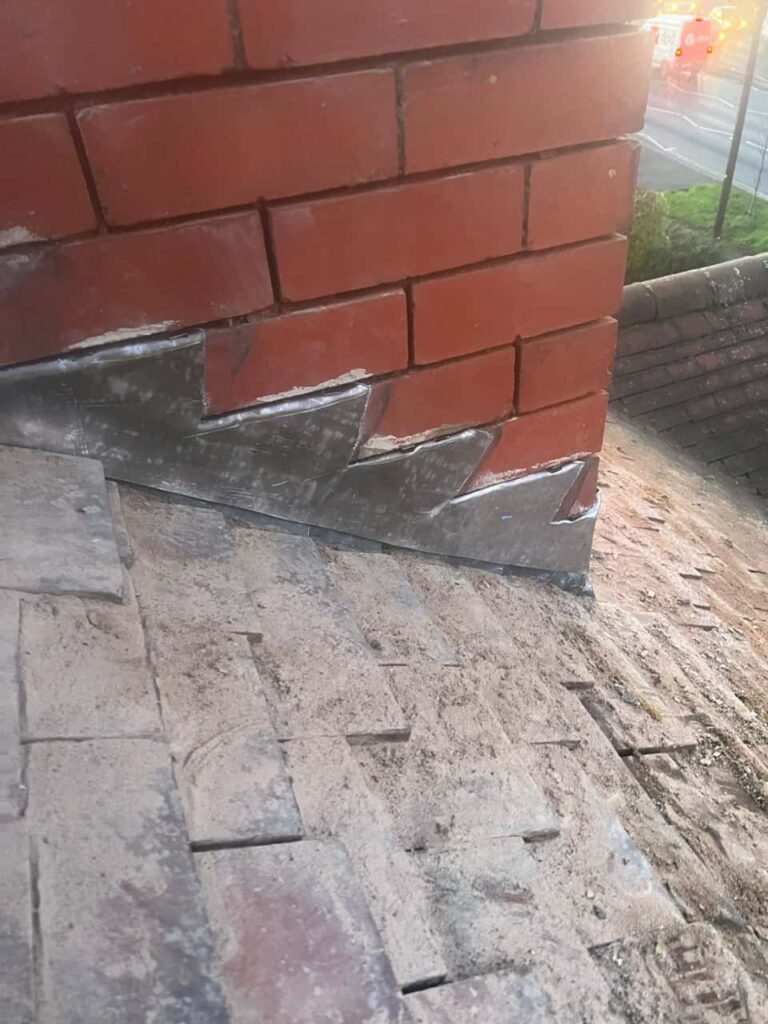 This is a photo of new leadwork being installed around an old chimney. Works carried out by Cambourne Roofing Repairs